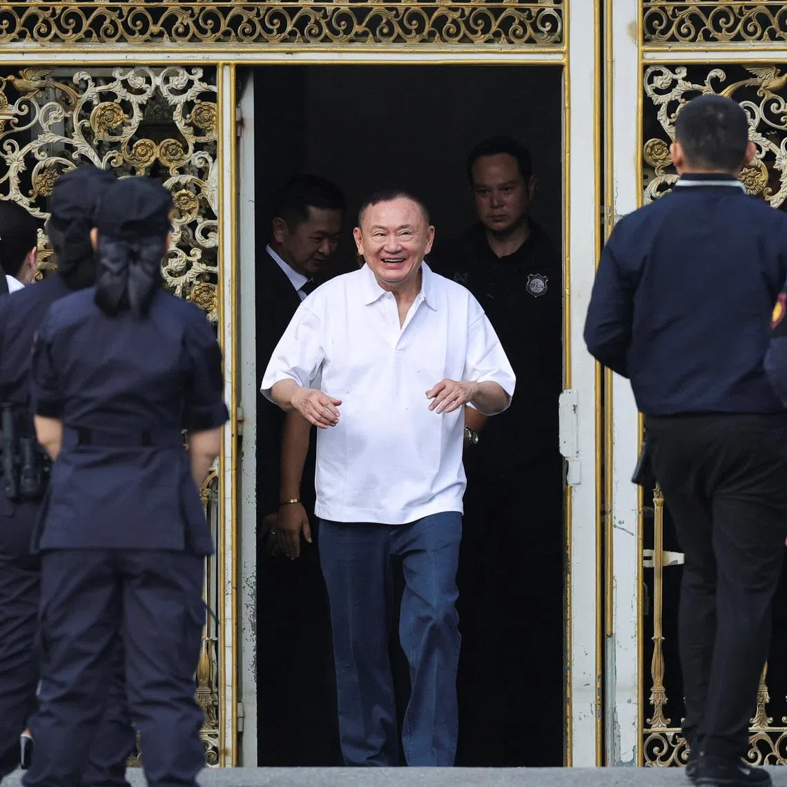 Former Thai Prime Minister Thaksin Shinawatra reacts following his release on parole after serving eight months of his one-year sentence at Klong Prem Central Prison in Bangkok, on May 11.