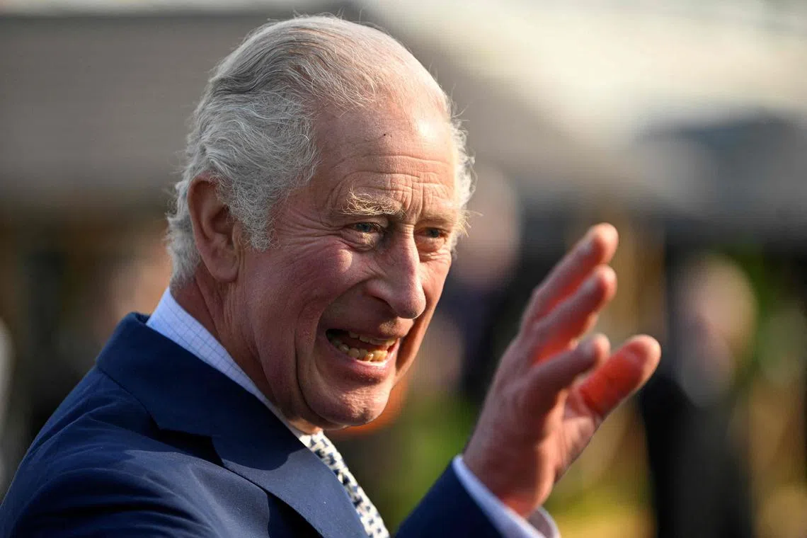 Britain's King Charles III waves as he arrives for a visit to the 2023 RHS Chelsea Flower Show in London on May 22, 2023. The Chelsea flower show is held annually in the grounds of the Royal Hospital Chelsea. (Photo by TOBY MELVILLE / POOL / AFP)