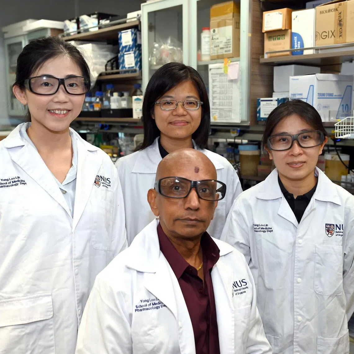 NUS Centre for Cancer Research assistant professor Alan Prem Kumar (centre, foreground) with researchers (background, from left) Cai Wanpei, Lam Hiu Yan and Xianning Lai, who found that a targeted drug that can block a ‘master switch’ that drives tumour growth in triple negative breast cancer.