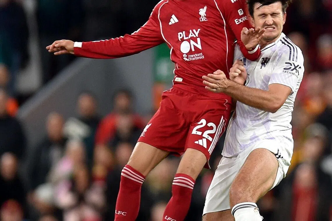 Liverpool's Hugo Ekitike battles for the ball with Manchester United's Harry Maguire during their Premier League clash.