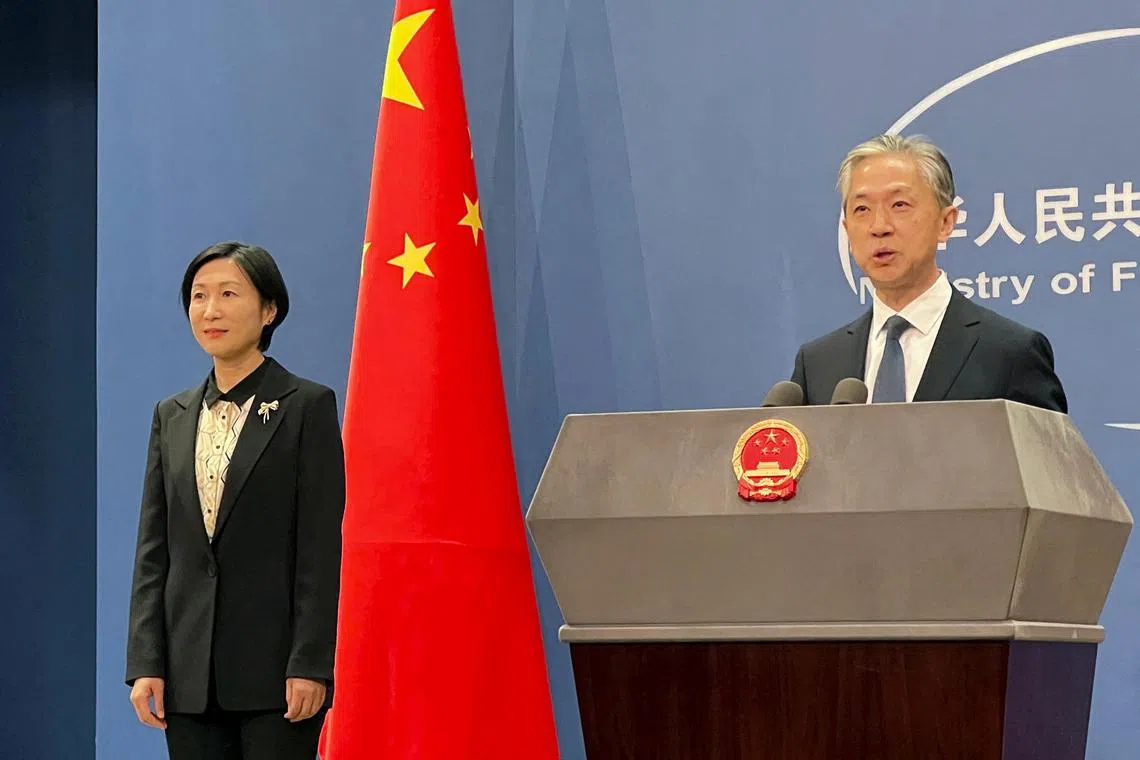 Chinese Foreign Ministry spokesman Wang Wenbin (right) accused the United States on Friday of “naked economic coercion and technological bullying”. 