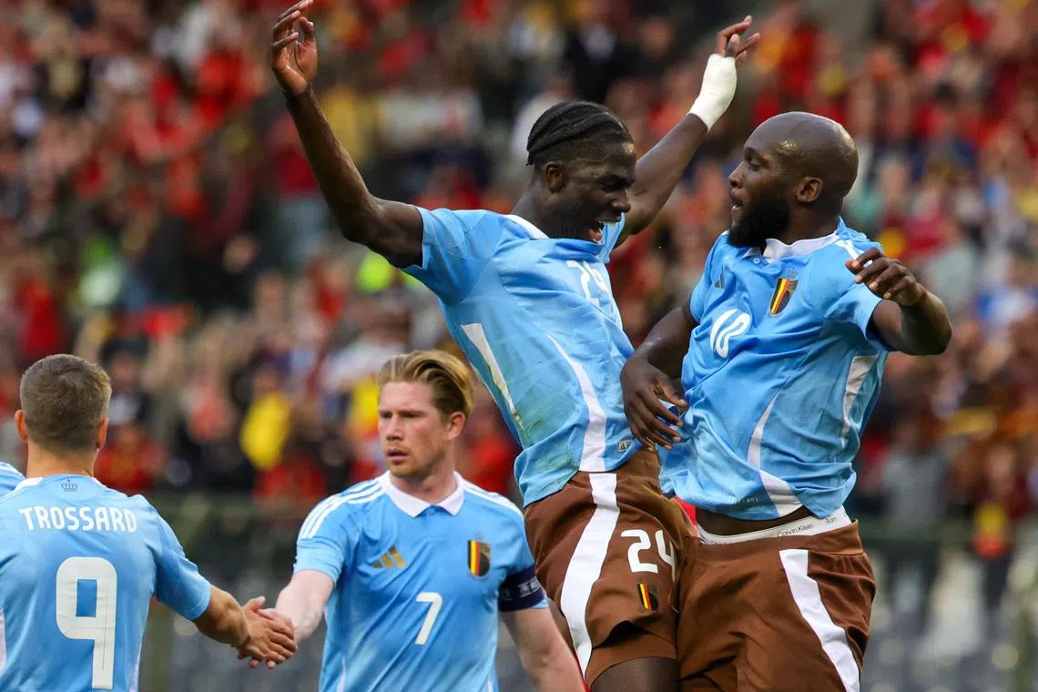 Belgium's Romelu Lukaku (right) celebrates with teammates after scoring the opening goal from the penalty spot.