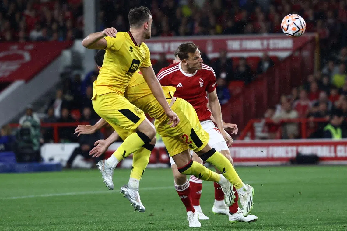 Nottingham Forest's New Zealand striker Chris Wood (centre) heads home their second goal against Sheffield United.