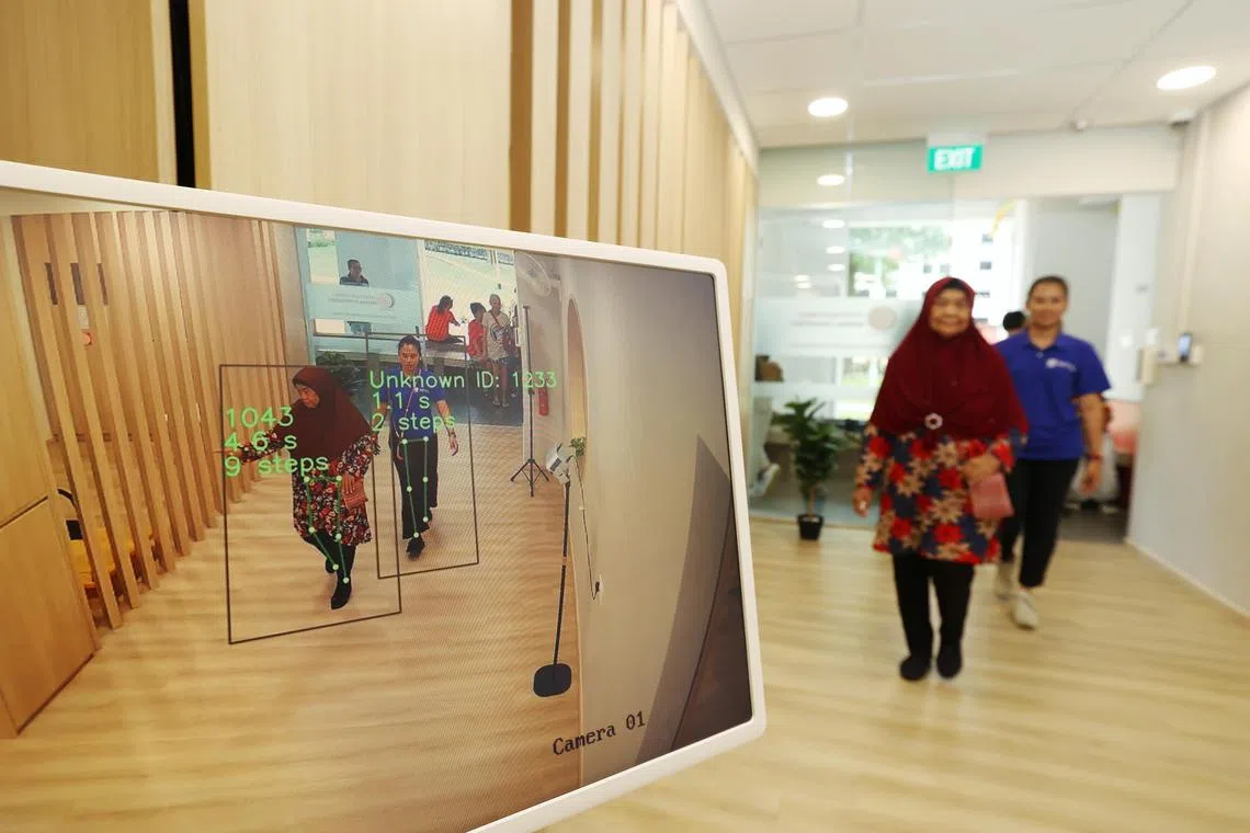 Madam Rosnah Sulaiman, 76, (left) entred the centre without having to tap in or register because of the facial recognition technology. She was accompanied by Ms Sarah Zawani 33, a staff of the THK Active Ageing Centre (AAC) @ Bedok