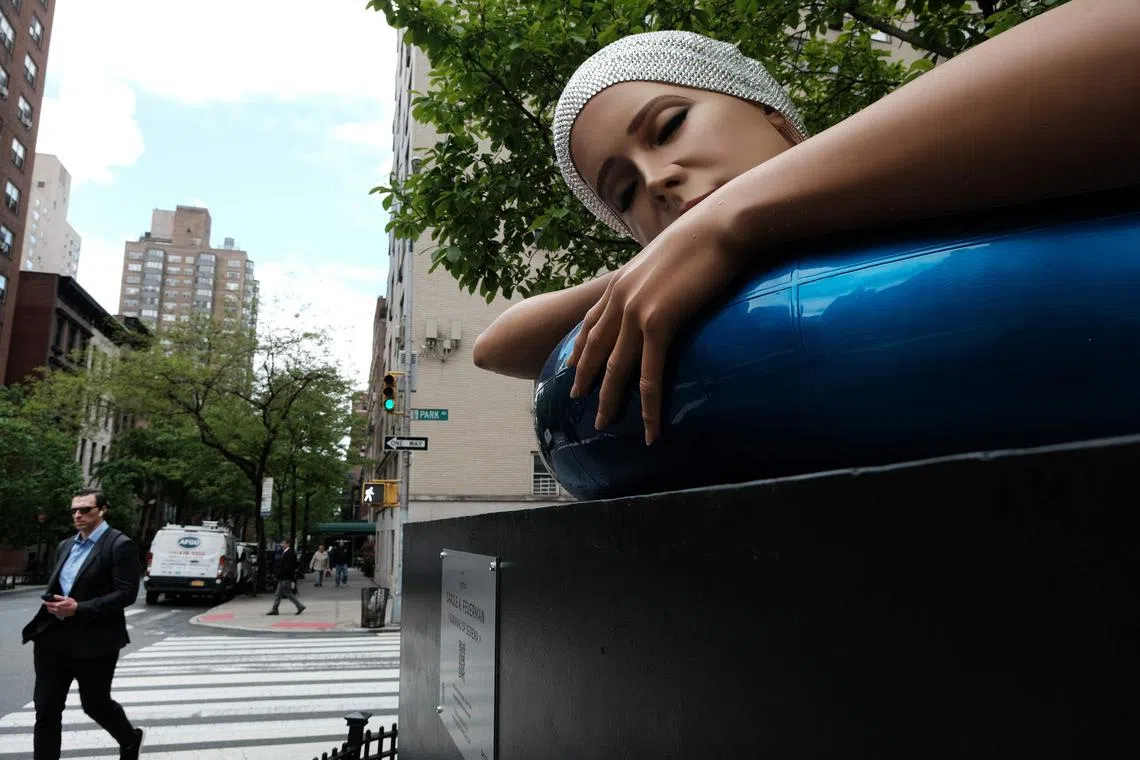 One of American artist Carole A. Feuerman's hyper-realistic sculptures of swimmers is displayed along Park Avenue on May 04, 2023 in New York City. The nine works, from 34th Street to 38th Street in Manhattan’s Murray Hill neighbourhood, show swimmers in vibrant colours resting on inner tubes, sitting on beach balls and in divining positions. 