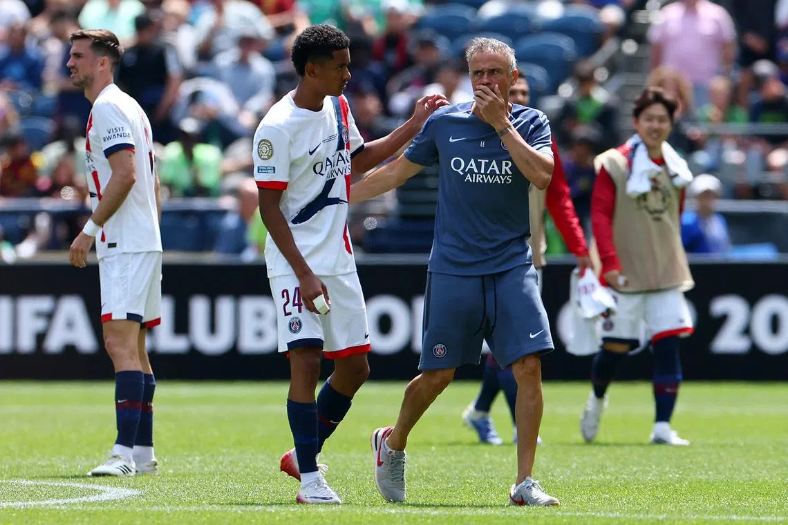 FILE PHOTO: Soccer Football - FIFA Club World Cup - Group B - Seattle Sounders v Paris St Germain - Lumen Field, Seattle, Washington, U.S. - June 23, 2025 Paris St Germain coach Luis Enrique with Senny Mayulu before the start of the second half REUTERS/Agustin Marcarian/File Photo