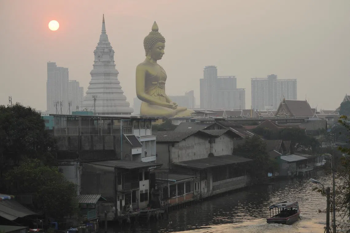 The giant Buddha statue of Wat Paknam Phasi Charoen temple is seen amid air pollution in Bangkok, on Feb 2, 2023.