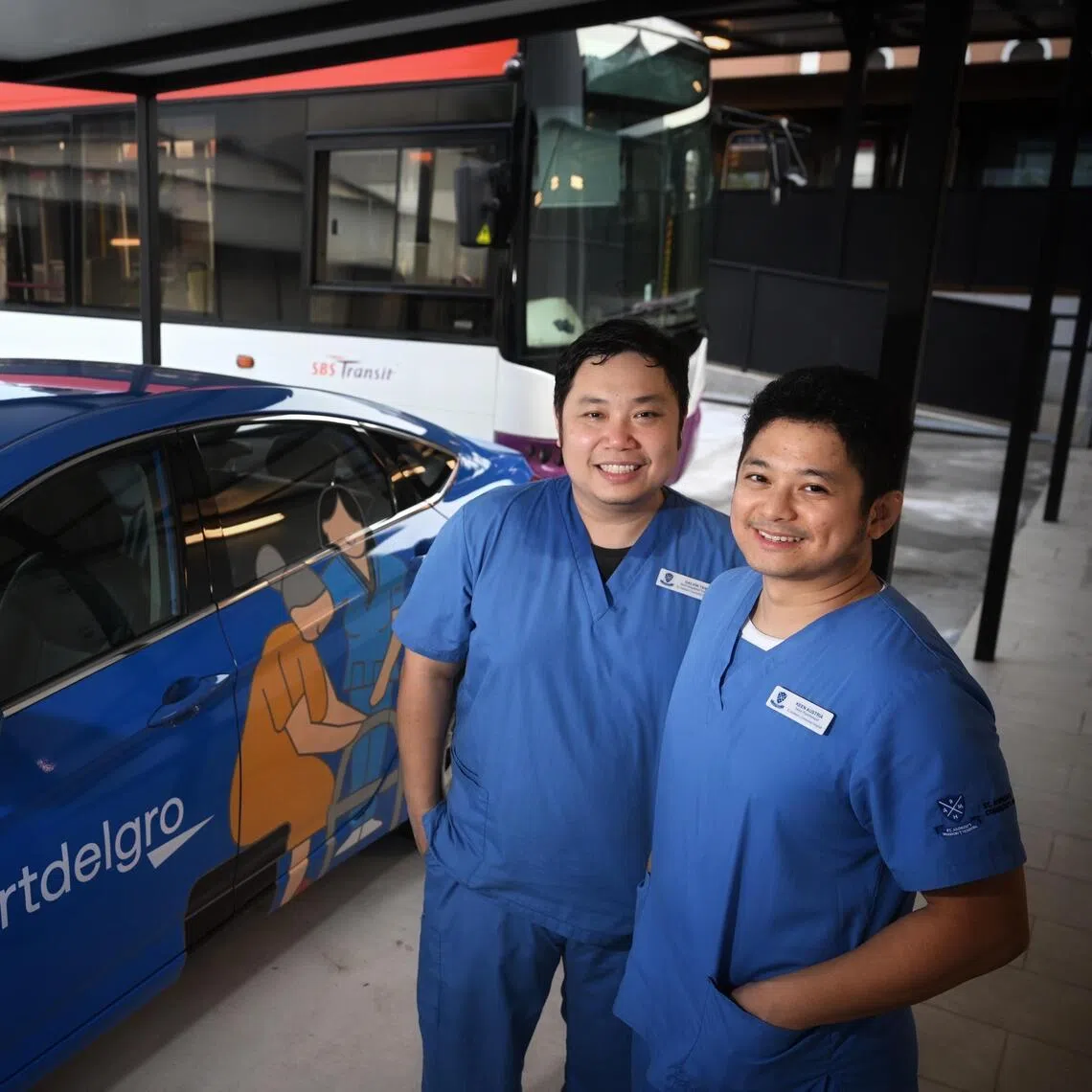 Galvin Tan, senior occupational therapist (left) and  Keen Austria, senior physiotherapist with the decommissioned taxi and bus that are used to train caregivers and patients at St. Andrew's Community Hospital (Bedok) on Nov 17, 2025.