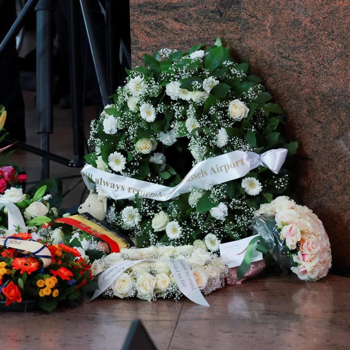 Flowers are laid in front of a commemorative plaque at Brussels Airport in Zaventem, Belgium on March 22, 2026.