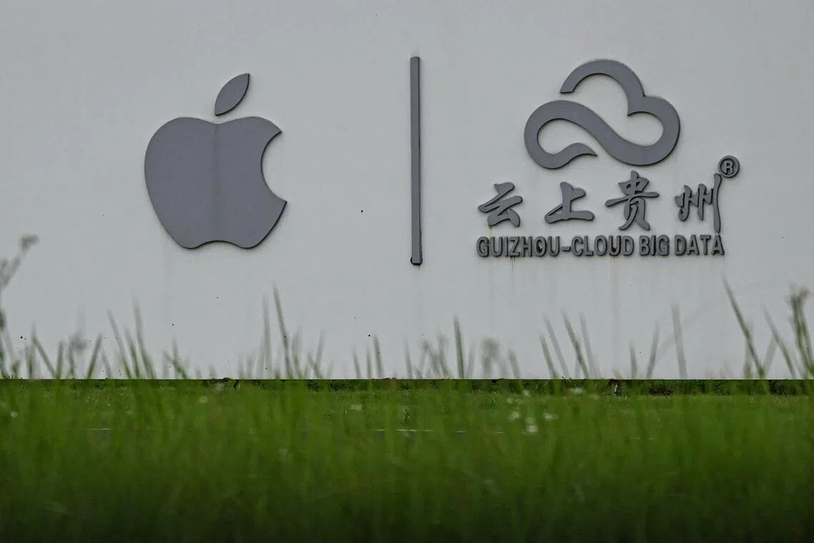 The photo taken on July 24, 2026 shows the signage of US technology company Apple's data center in Guian New Area in Guiyang, in southwestern China's Guizhou Province. China is on course to nearly double its data centre capacity within the next five years, as globally countries aim to avoid a computing crunch that could stymie AI expansion. (Photo by Jade GAO / AFP) / TO GO WITH: China-economy-tech-AI, FOCUS by Agatha CANTRILL