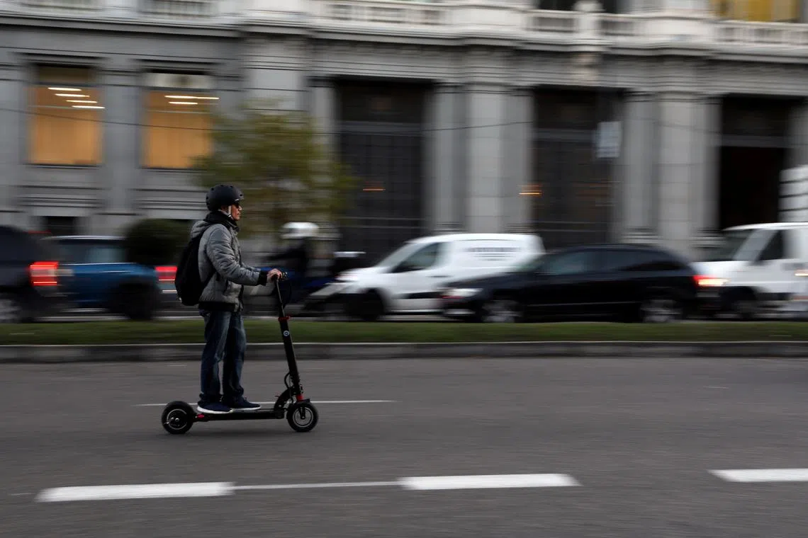 FILE PHOTO: A man rides an electric scooter in Madrid, Spain, December 4, 2018. REUTERS/Susana Vera/File Photo