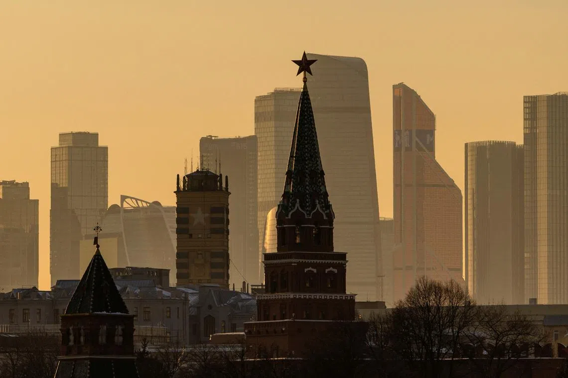 FILE PHOTO: A view shows the Moscow City international business centre behind the Borovitskaya tower of the Kremlin during sunset in Moscow, Russia, February 23, 2025. REUTERS/Maxim Shemetov/File Photo