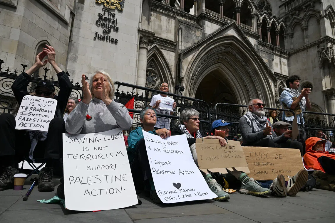 FILE PHOTO: People attend a demonstration opposing the government's decision to ban Palestine Action as a terror organisation, following a Court of Appeal ruling on the lawfulness of proscribing the pro-Palestinian group under terrorism laws, outside the Royal Courts of Justice, in London, Britain, June 15, 2026. REUTERS/Chris J. Ratcliffe/File Photo