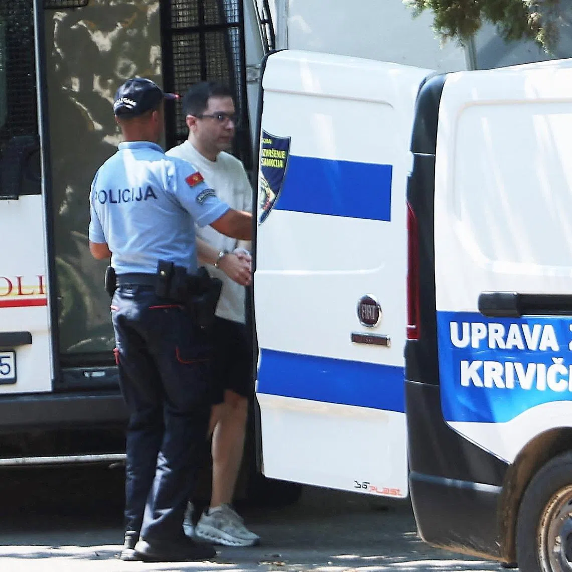 A police officer escorts an Iranian national, who is suspected of hacking attacks that damaged U.S. infrastructure to the tune of $3.4 billion according to  Montenegrin police, and was arrested in a joint operation with the FBI, to an investigating judge on a U.S. extradition request, in Podgorica, Montenegro, June 26, 2026. REUTERS/Stevo Vasiljevic