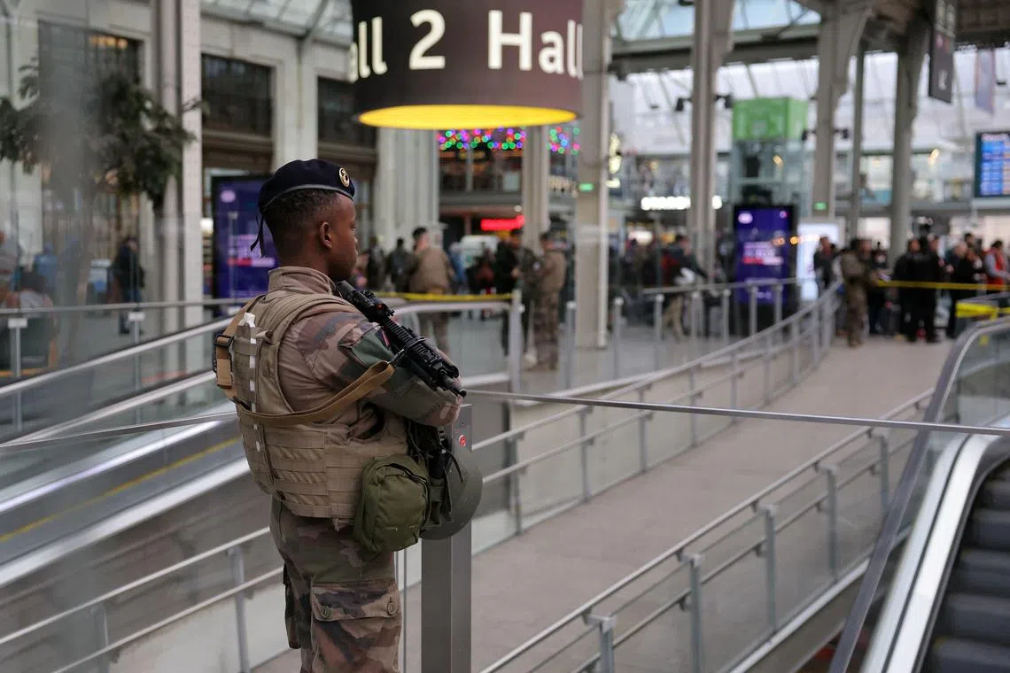 A French soldier stands guard in a hall after a knife attack at Paris's Gare de Lyon railway station.