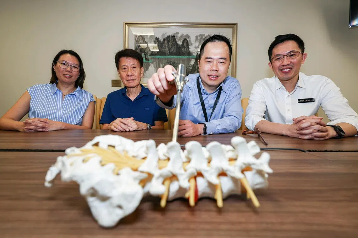 Thomas Tan, a consultant in neurosurgery at the National Neuroscience Institute@Tan Tock Seng Hospital (second from right), demonstrated where the specialised instruments accessed the spine while minimising damage to surrounding tissues.