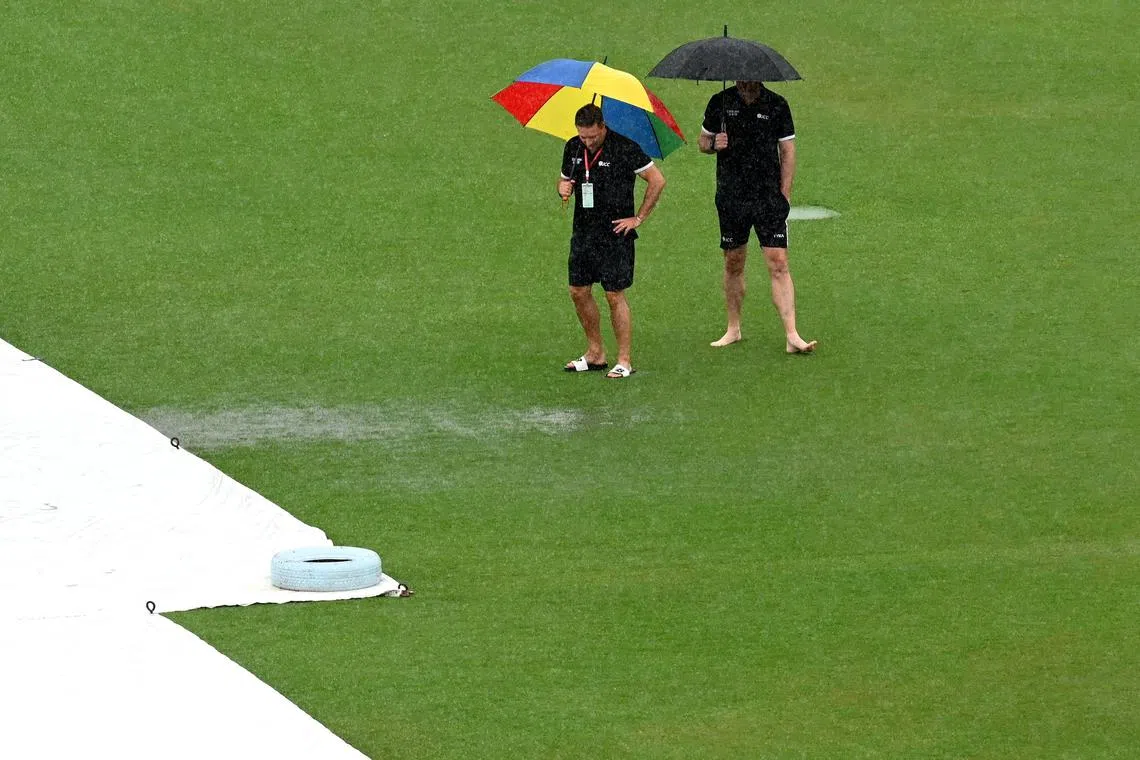 Umpires Richard Kettleborough (left) and Michael Gough of England inspect the pitch as it rains before the start of the second and last cricket Test between Pakistan and Bangladesh, at the Rawalpindi Cricket Stadium on Aug 30, 2024.