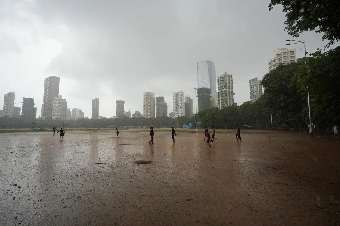 FILE PHOTO: Children play in the rain in Mumbai, India, June 20, 2024. REUTERS/ Hemanshi Kamani/File Photo