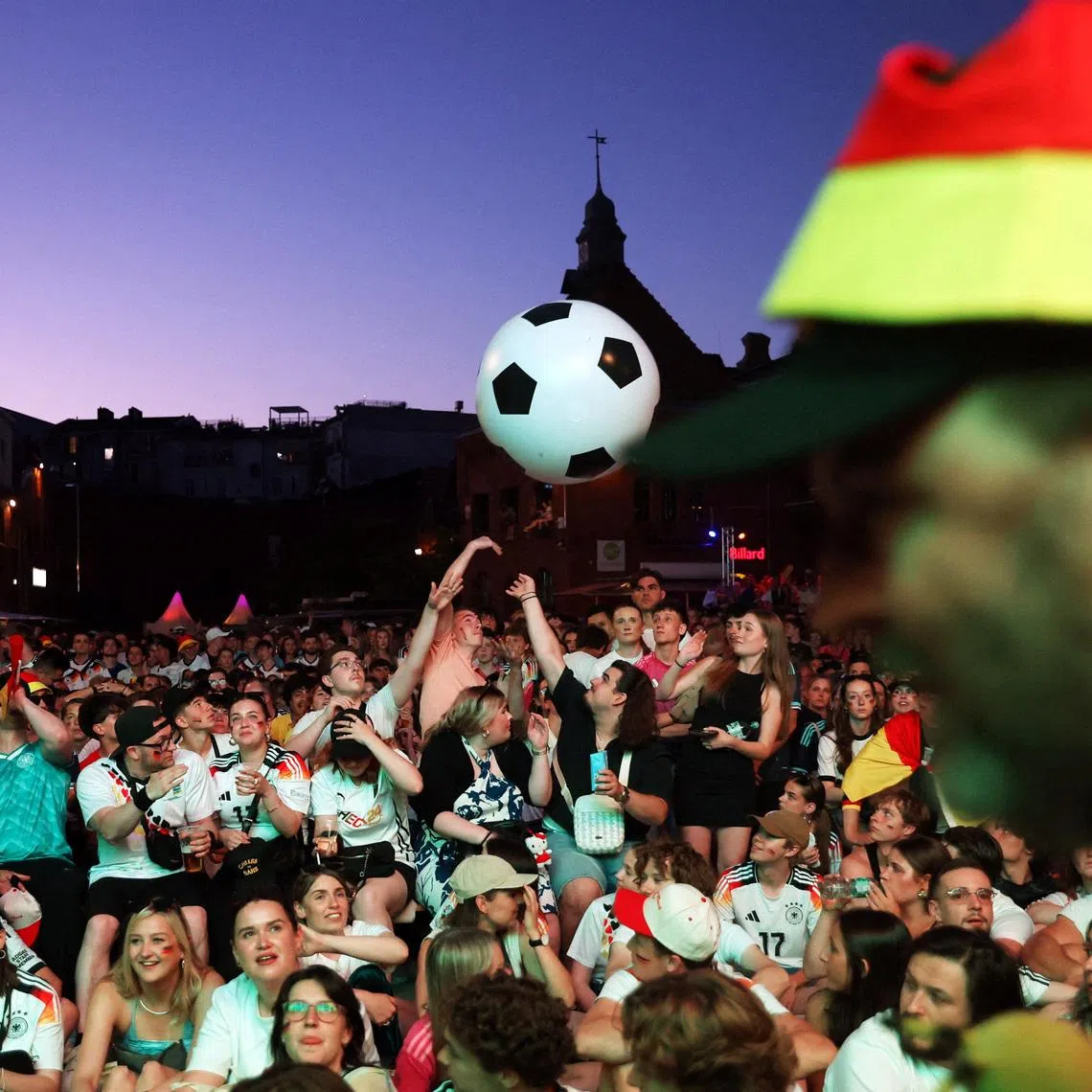 Soccer Football - FIFA World Cup 2026 - Group E - Ecuador v Germany - Fans gather in Berlin - Berlin, Germany - June 25, 2026 Germany fans play with an inflatable football as they watch the match on a big screen at the Kulturbrauerei in Berlin REUTERS/Maryam Majd
