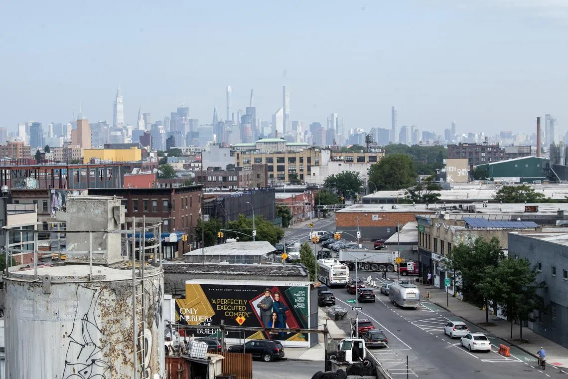 The Manhattan skyline is shrouded in smoke as seen from a Brooklyn neighbourhood on Thursday morning.