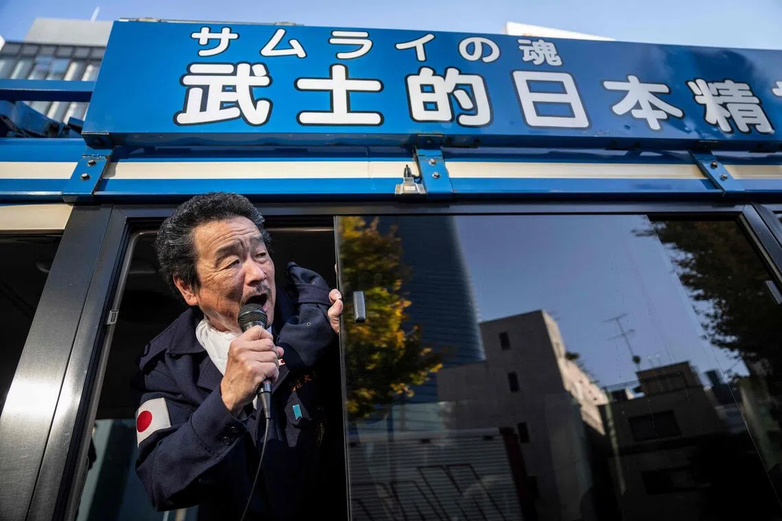 A member of the ultra-nationalist group Taikosha shouts slogans out of a van during a rally in Tokyo. 