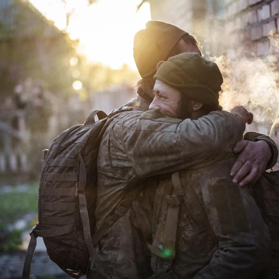 Servicemen of the Ukrainian Armed Forces, Andrii and Vasyl, hugging after returning from a frontline position, amid Russia's attack on Ukraine, in Donetsk region, Ukraine April 29.