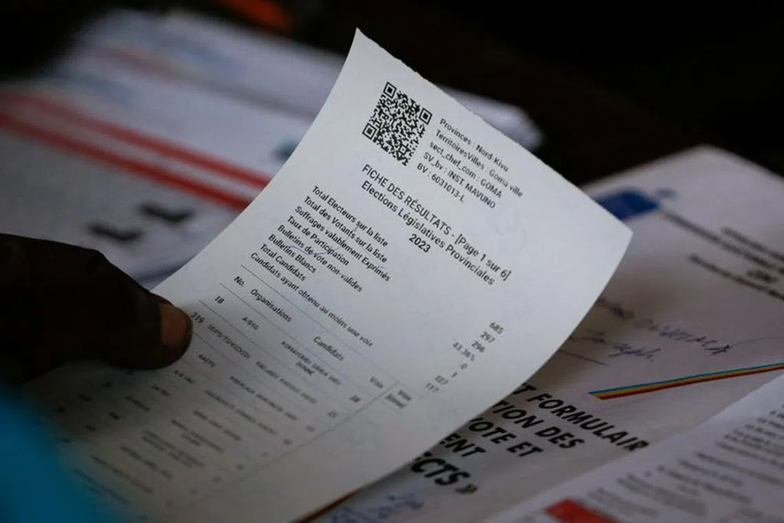 An Independent National Electoral Commission (CENI) official confirms tally casted votes at the Mavuno polling station following the parliamentary and presidential elections in Goma, North Kivu province of the Democratic Republic of Congo December 21, 2023. REUTERS/Thomas Mukoya