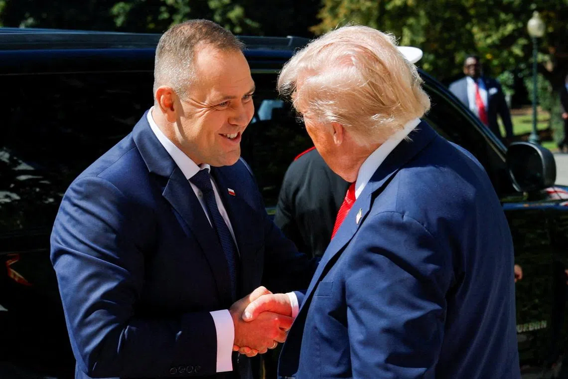 U.S. President Donald Trump greets the President of Poland Karol Nawrocki at the White House in Washington, D.C., U.S., September 3, 2025. REUTERS/Brian Snyder