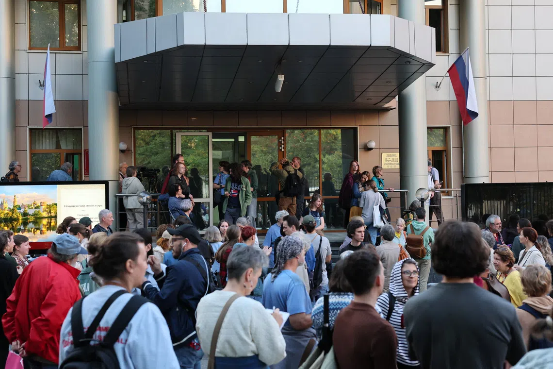 People wait outside a court building ahead of an expected hearing for children's hospice founder Lida Moniava, who was reportedly detained and charged with deliberately spreading false information about the Russian army in connection with the conflict against Ukraine, in Moscow, Russia, September 3, 2026. REUTERS/Anastasia Barashkova