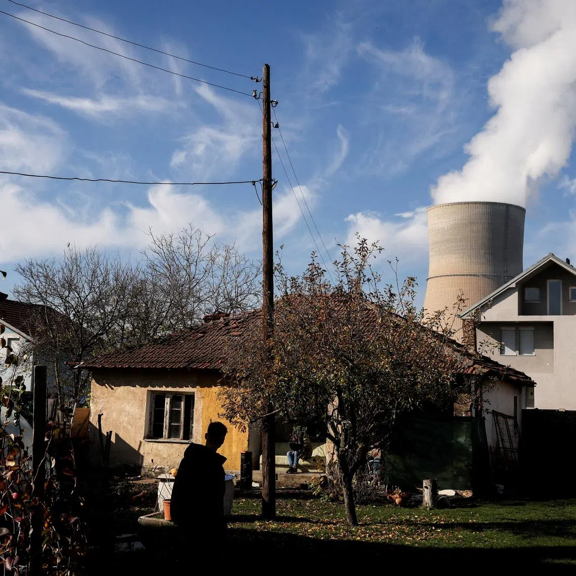 A man walks at his garden near the coal-fired power plant in Obilic, Kosovo November 13, 2025. REUTERS/Valdrin Xhemaj/File Photo