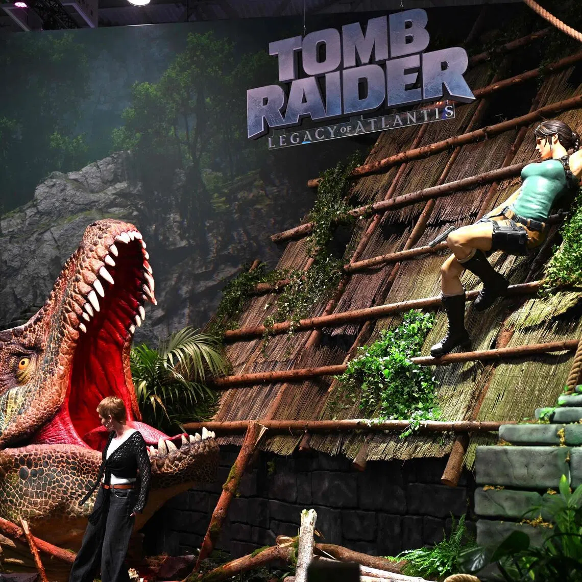 A visitor poses at the Tomb Raider: Legacy of Atlantis video game at Gamescom in Cologne, Germany on Aug 26.