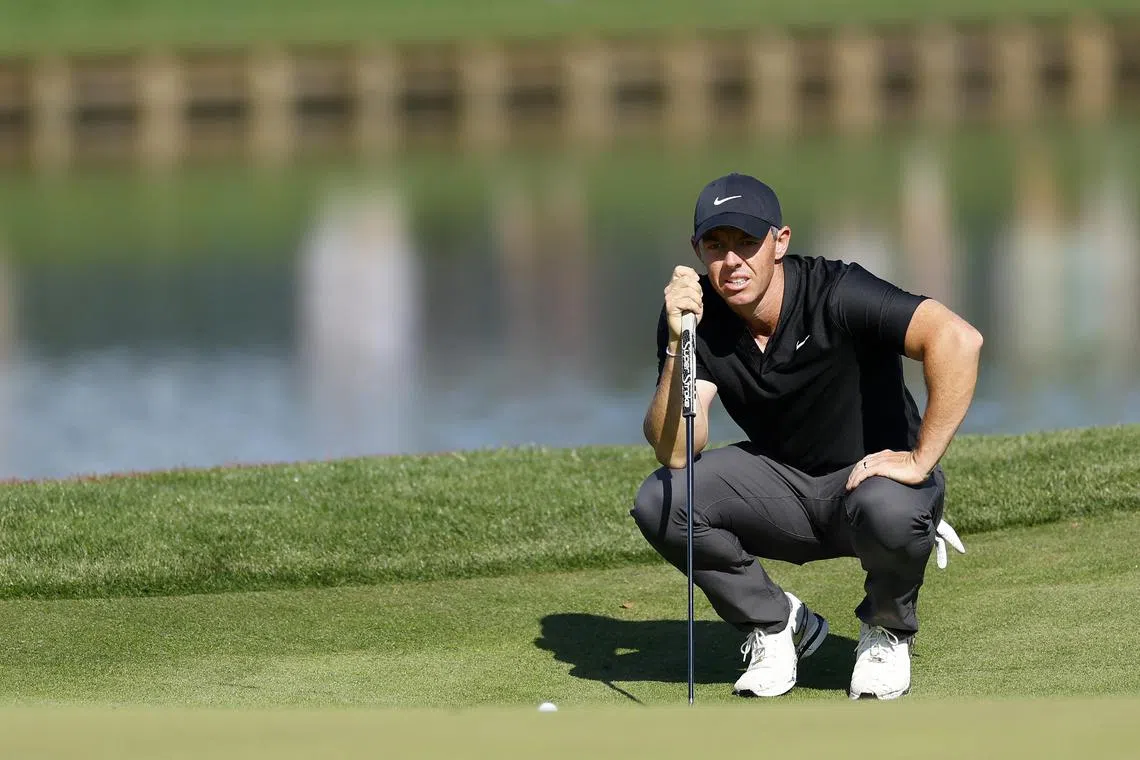 Rory McIlroy of Northern Ireland lines up a putt on the 16th green during the first round of The Players Championship.