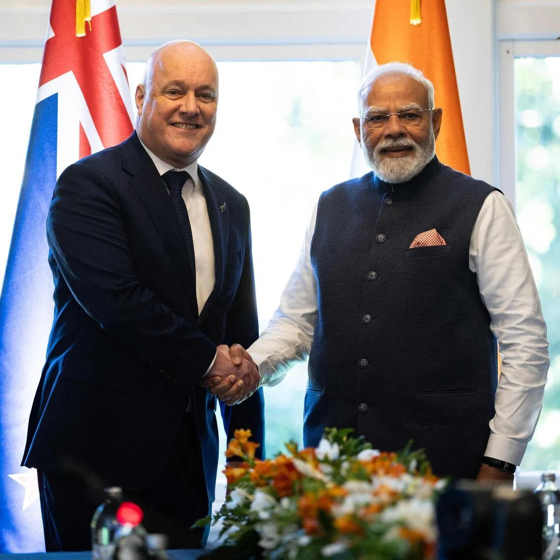 India’s Prime Minister Narendra Modi (right) shakes hands with New Zealand Prime Minister Christopher Luxon at Government House in Auckland on July 11.