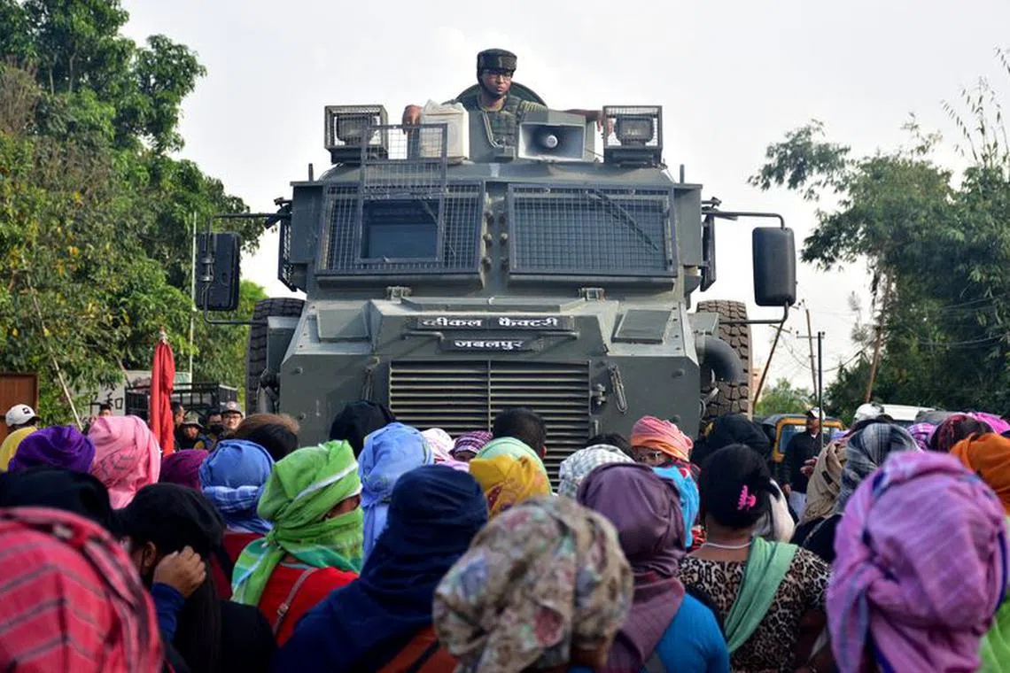 Residents from Meitei community stop an army vehicle from moving towards a gunfight site after a fresh clash between members of rival ethnic groups, in Imphal, Manipur, India, November 7, 2023. REUTERS/Stringer