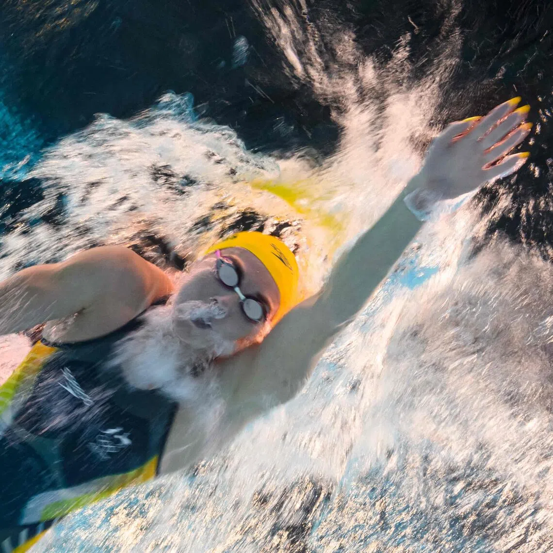 (FILES) An underwater view shows Australia's Ariarne Titmus competing in a heat of the women's 800m freestyle swimming event during the Paris 2024 Olympic Games at the Paris La Defense Arena in Nanterre, west of Paris, on August 2, 2024. Four-time Olympic gold medallist Ariarne Titmus announced her immediate retirement from swimming on October 16, 2025, calling it a "really tough" decision as she was lauded as "a living legend". (Photo by François-Xavier MARIT / AFP)