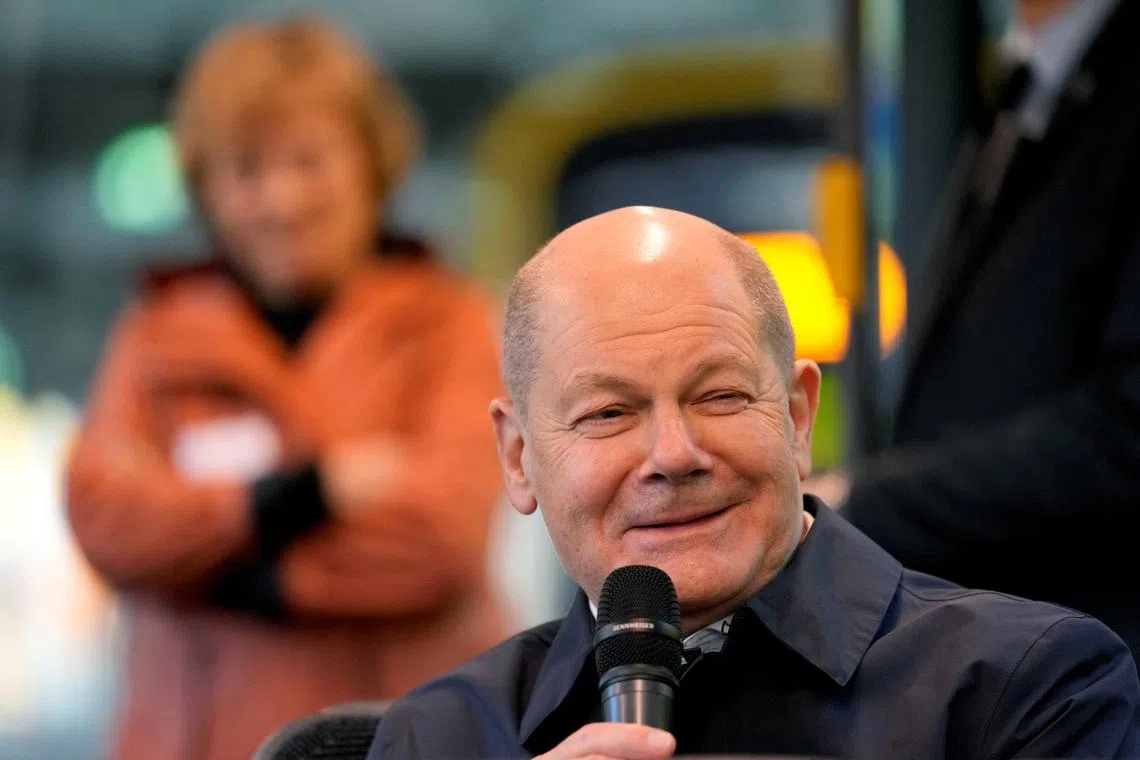 FILE PHOTO: German chancellor Olaf Scholz smiles as he sits in a tram talking to participants of the Democracy project 'metro-polis' in Dresden, Germany, Thursday, Feb. 29, 2024.  Ebrahim Noroozi/Pool via REUTERS/File Photo