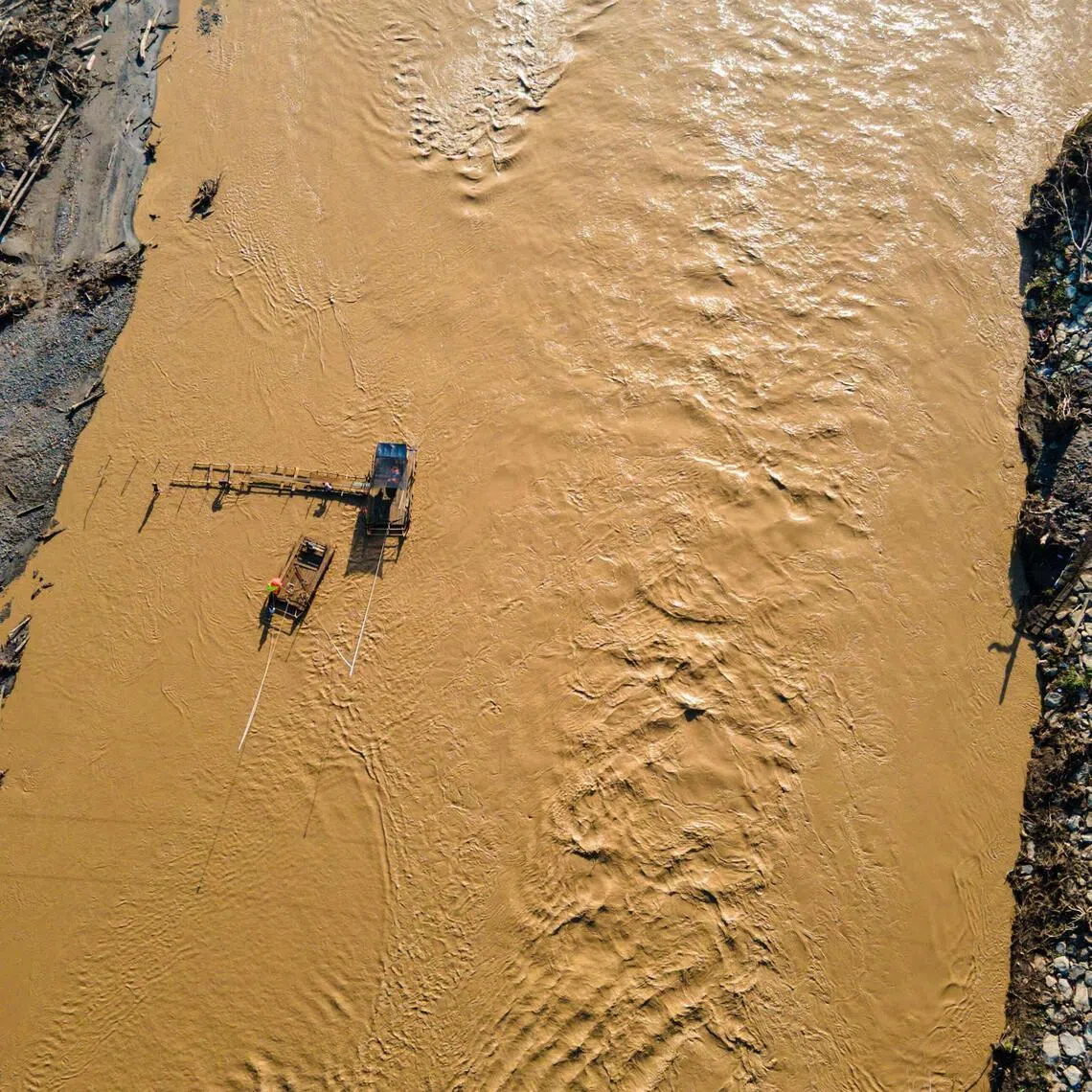 People rafting across the Peusangan river in the aftermath of flash floods that destroyed villages in Aceh province on Jan 5.