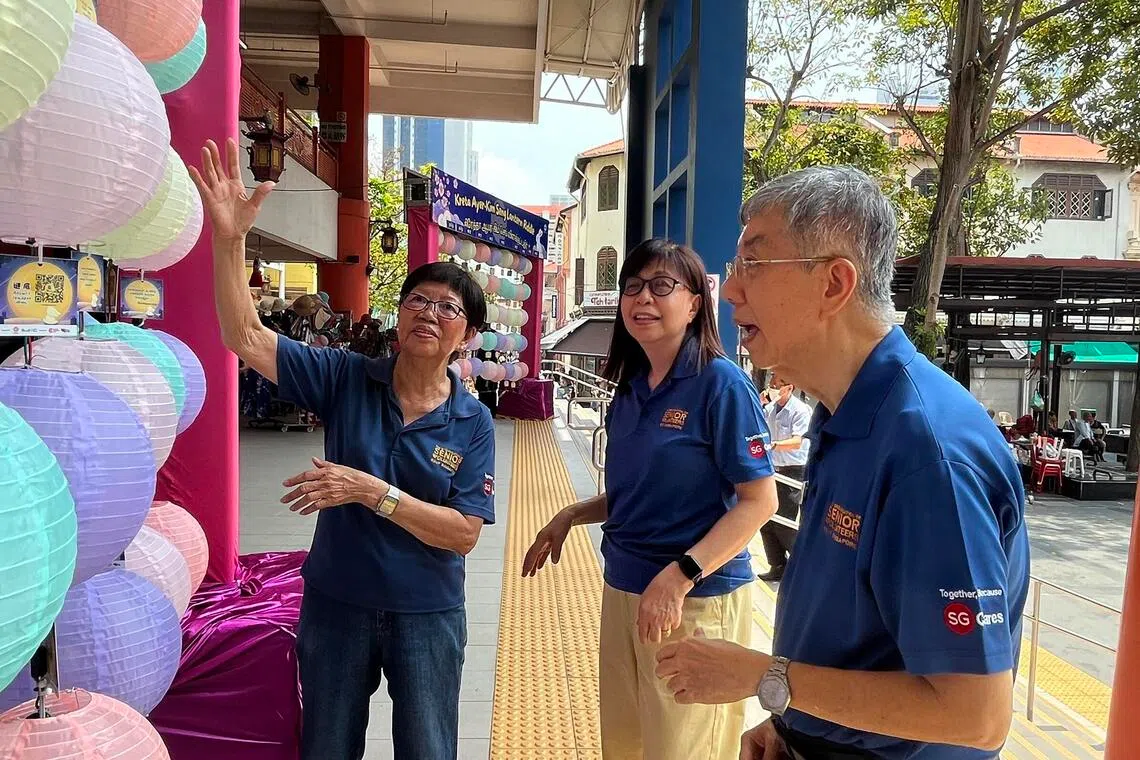 (From left) RSVP Singapore volunteers Chua Chor Keng, Hum Swee Kin, and Teo Wei Min at Kreta Ayer Square on Sept 21.