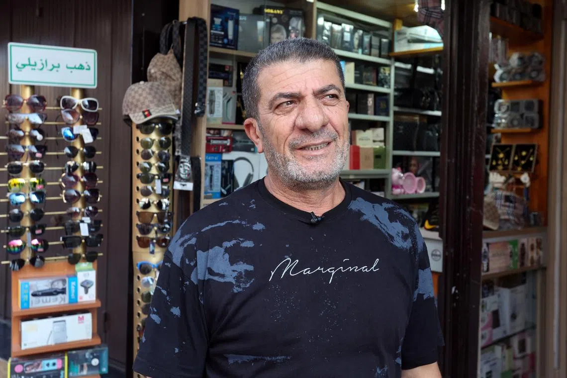 Shop owner Mohamed Ftouni attends an interview with Reuters as he stands outside his shop in Tyre, southern Lebanon August 26, 2024. REUTERS/Aziz Taher