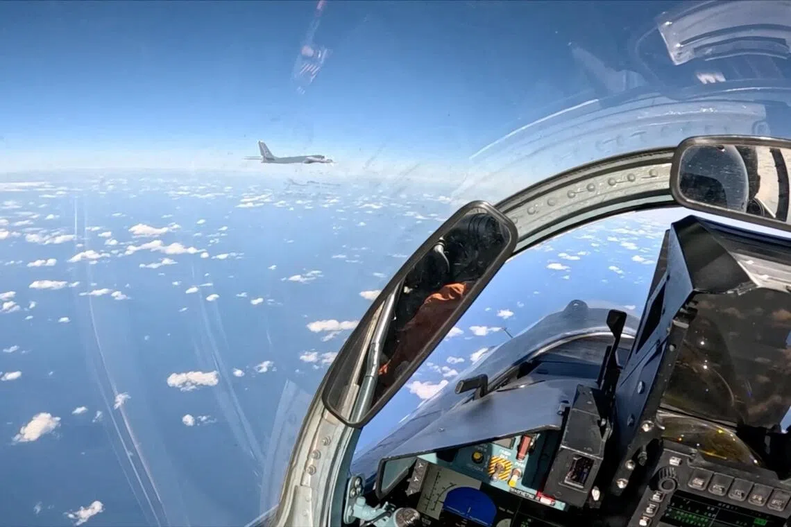 A Russian Tu-95MS strategic bomber flies over neutral waters in the Sea of Japan, as seen from the cockpit of a Russian aircraft.
