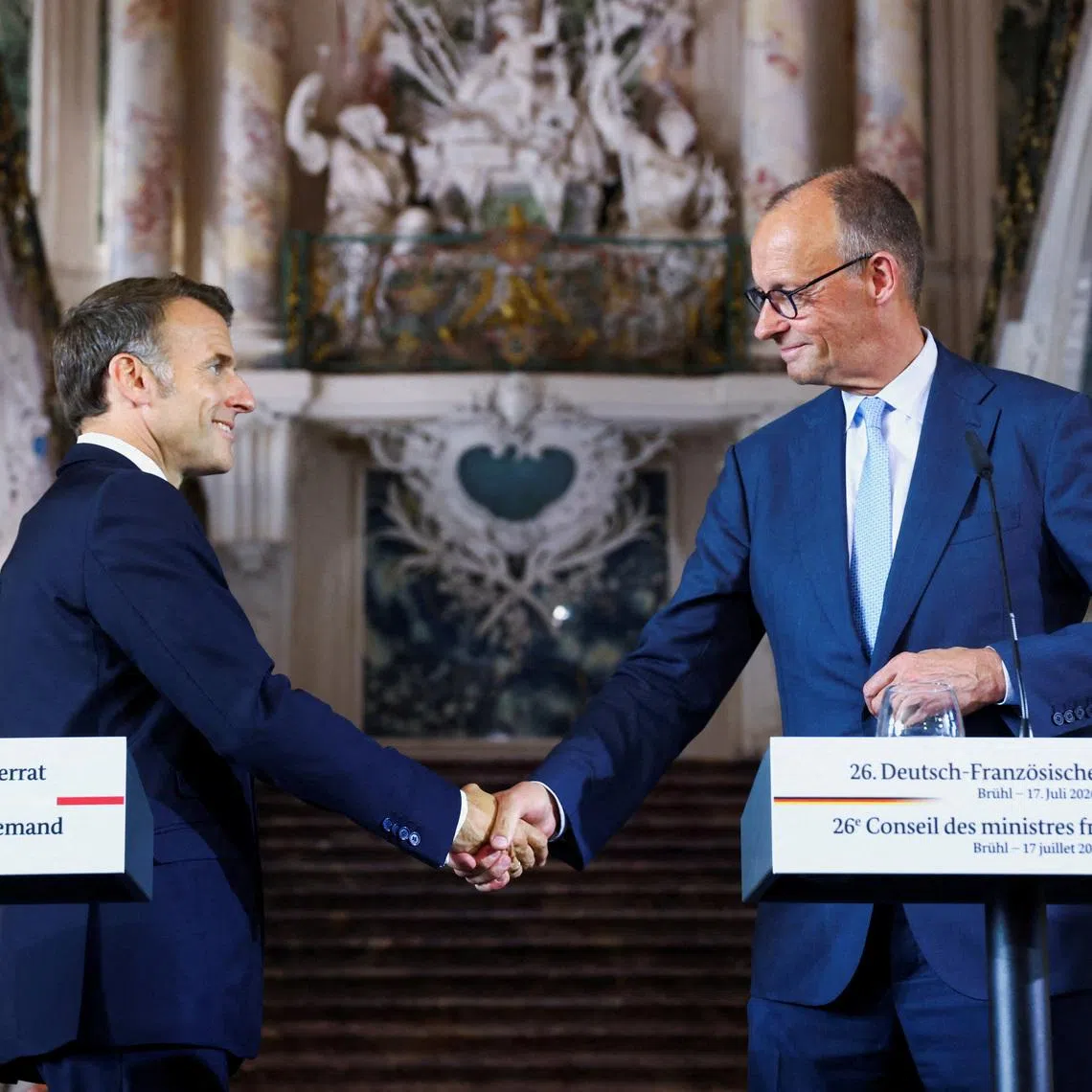 German Chancellor Friedrich Merz and French President Emmanuel Macron shake hands after a press conference at Schloss Augustusburg in Bruehl, Germany, July 17, 2026. REUTERS/Thilo Schmuelgen