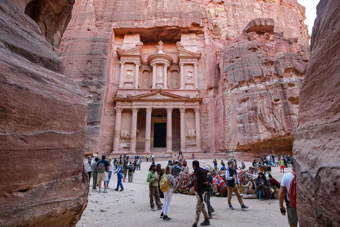 Visitors tour near the Treasury at the ruins of the ancient Nabatean city of Petra in southern Jordan.