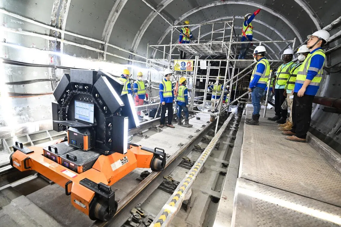 Workers doing finishing works using epoxy and grouting to seal up any gaps inside the tunnel near Dakota MRT station during an update on progress of Circle Line tunnel strengthening works on March 26, 2026.