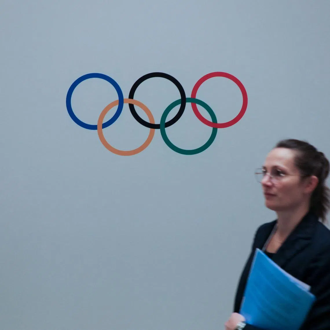 A woman walks past a logo of Olympics during a meeting of International Olympic Committee (IOC), ahead of the 141st IOC Session, in Mumbai, India, October 13, 2023. REUTERS/ Niharika Kulkarni