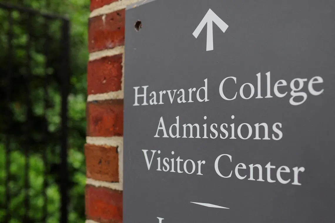 FILE PHOTO: A sign points the way to the Harvard College Admissions Visitors Center at Harvard University in Cambridge, Massachusetts, U.S., July 6, 2023.     REUTERS/Brian Snyder/File Photo