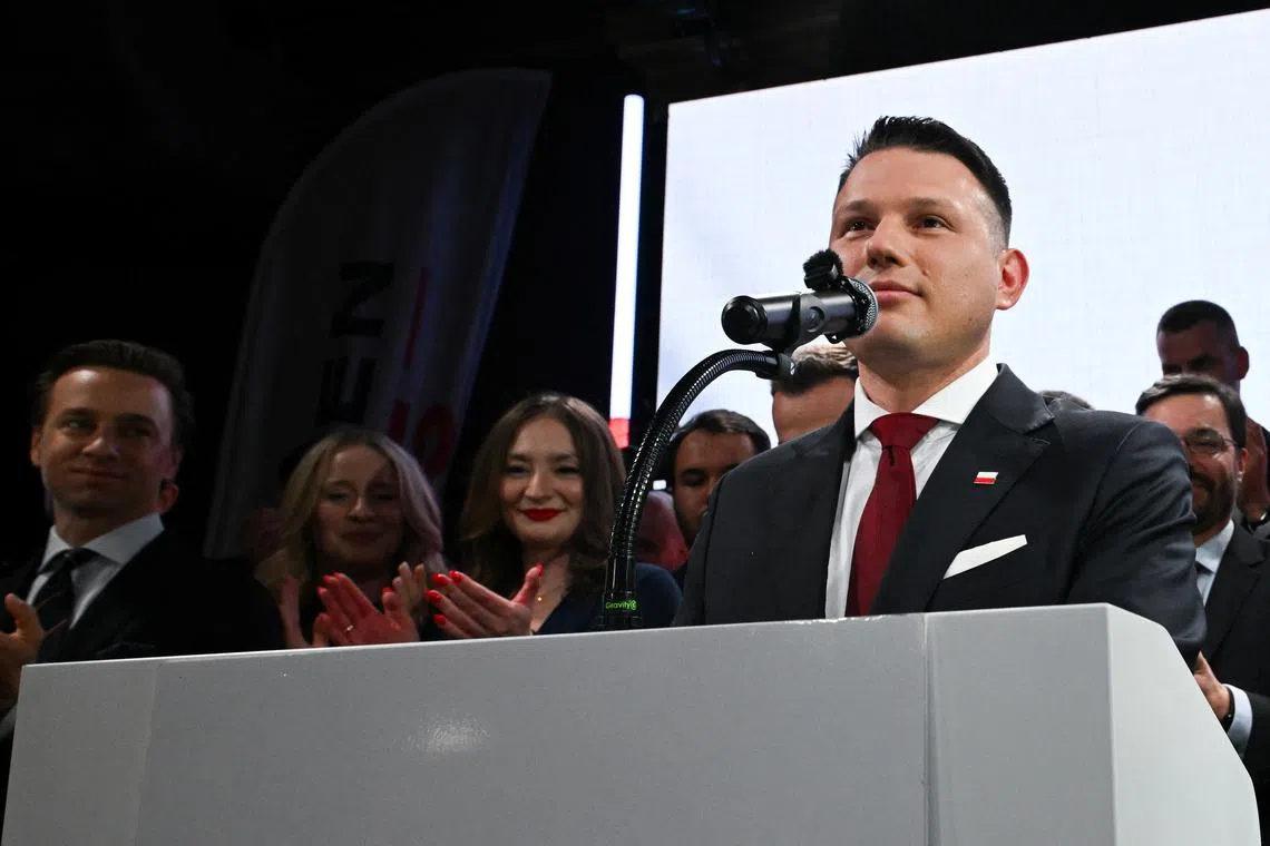 FILE PHOTO: Slawomir Mentzen, the presidential candidate of the far-right Confederation party, reacts to the exit poll for the first round of Poland's presidential election, in Warsaw, Poland, May 18, 2025. REUTERS/Kasia Strek/File Photo