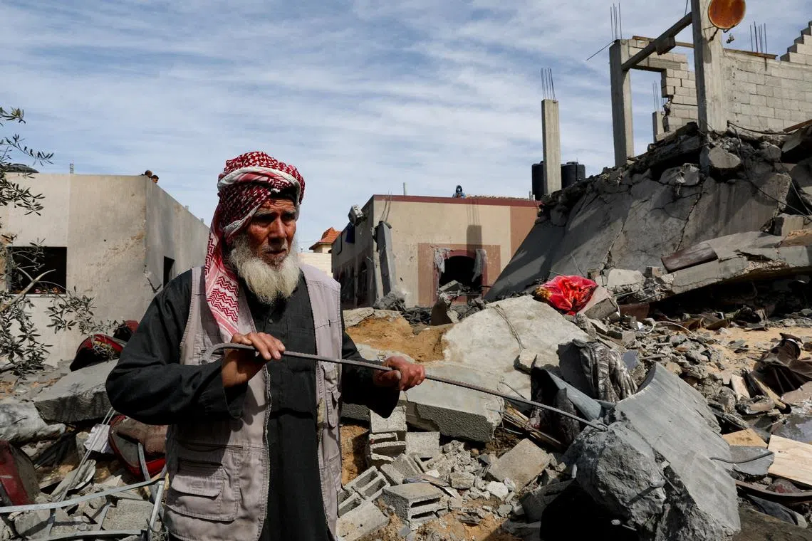 A Palestinian stands at the site of an Israeli strike on a house, amid the ongoing conflict between Israel and Hamas, in Rafah in the southern Gaza Strip, March 1, 2024. REUTERS/Ibraheem Abu Mustafa