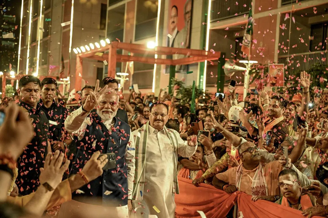 Prime Minister Narendra Modi greeting supporters at his Bharatiya Janata Party's headquarters in New Delhi, after winning a third term in office.