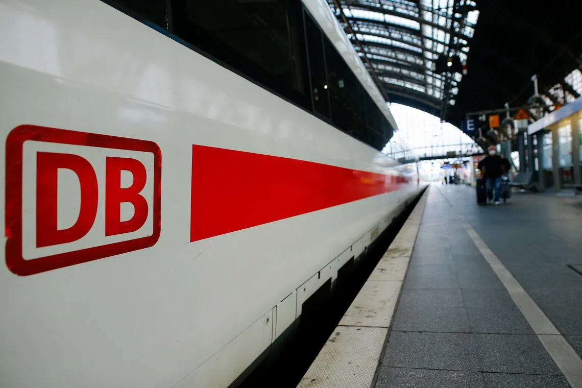 The logo of Deutsche Bahn is seen on a train at Cologne's main railway station, during a nationwide rail workers' strike, in Cologne, Germany, August 23, 2021. REUTERS/Thilo Schmuelgen/File Photo