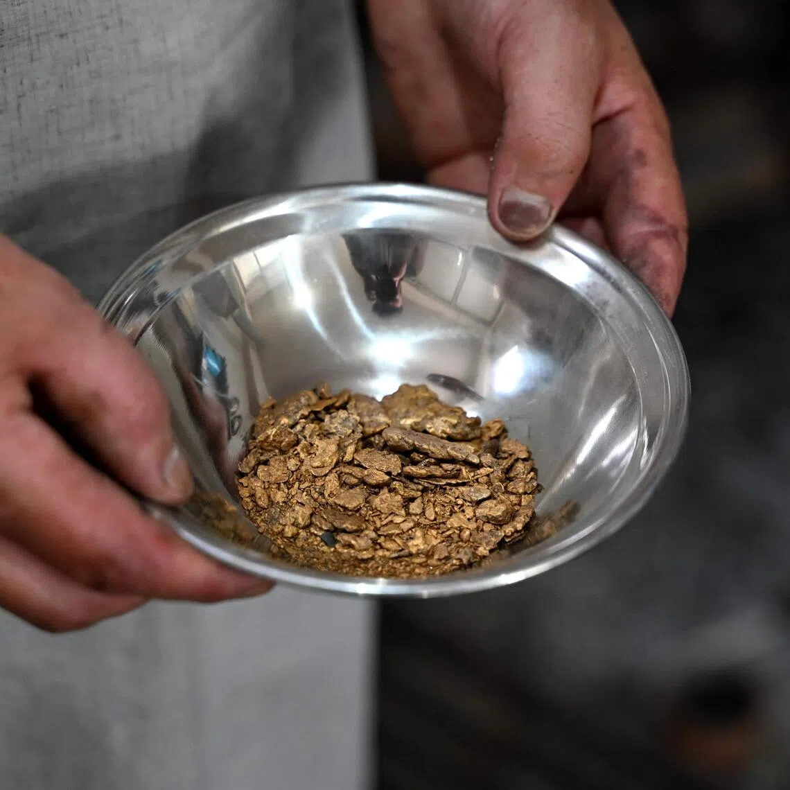 An Afghan goldsmith holding gold at a workshop in Fayzabad, in Afghanistan’s north-eastern Badakhshan province.